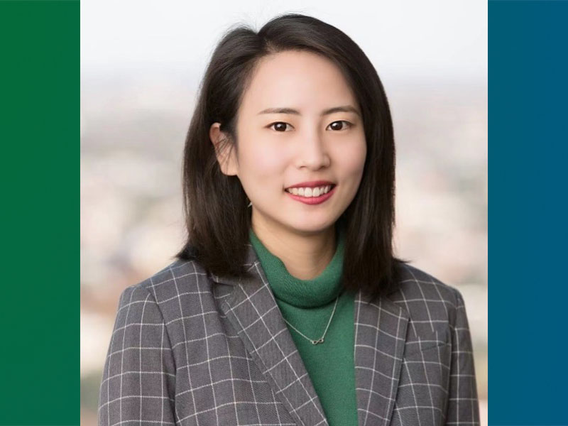 Headshot for Yixue Shao is a PhD candidate in the Department of Health Policy and Management, wearing plaid jacket standing by a window