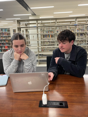 Amelia Nugent and Ethan Moran working on the zine