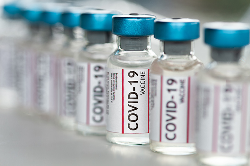 Stock photo of bottles labeled Covid vaccine