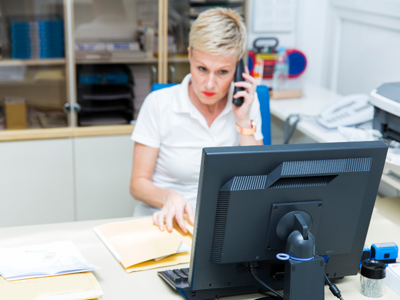 Woman receptionist with angry expression on face in a records office