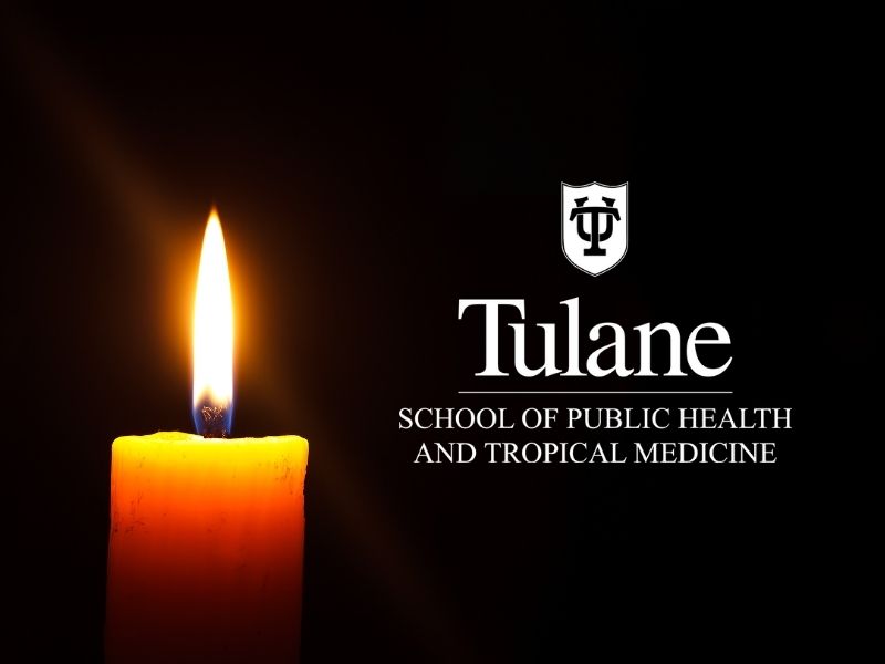 Candle set against a black background with Tulane School of Public Health Logo