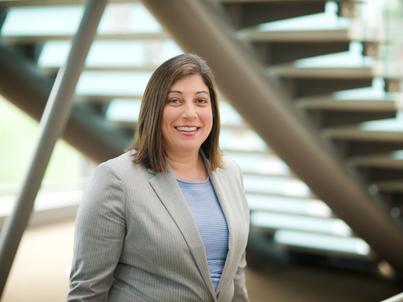 Debra Houry, headshot, wearing suite, stairs in background