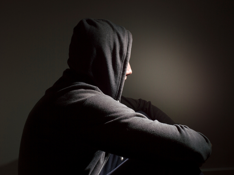A photo of an isolated person in a hoodie