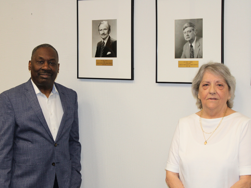 Dean Thomas LaVeist and Ms. Gladys Banta pose alongside Dr. James Banta’s dean portrait.