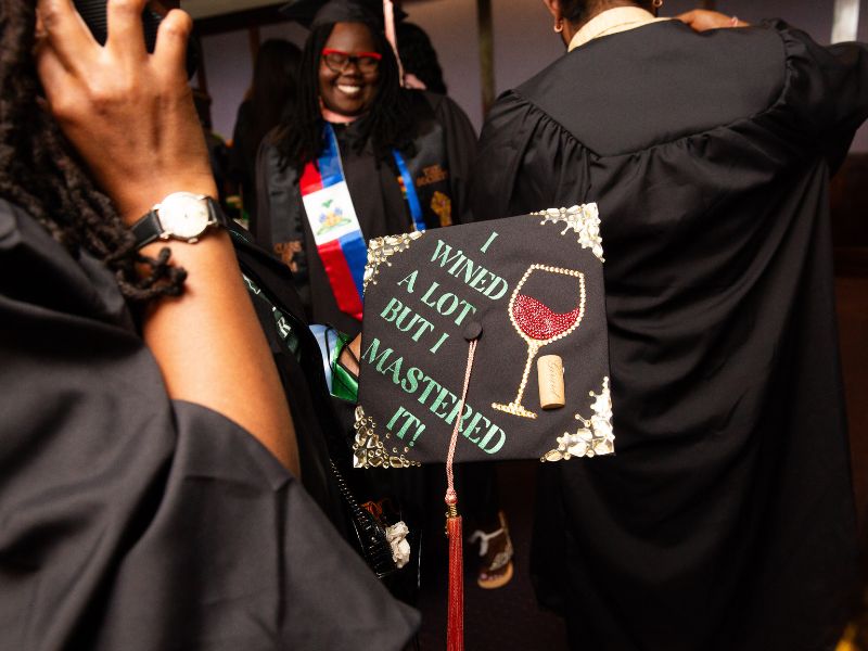 Mortarboard with joke about "Wining a lot but graduating"