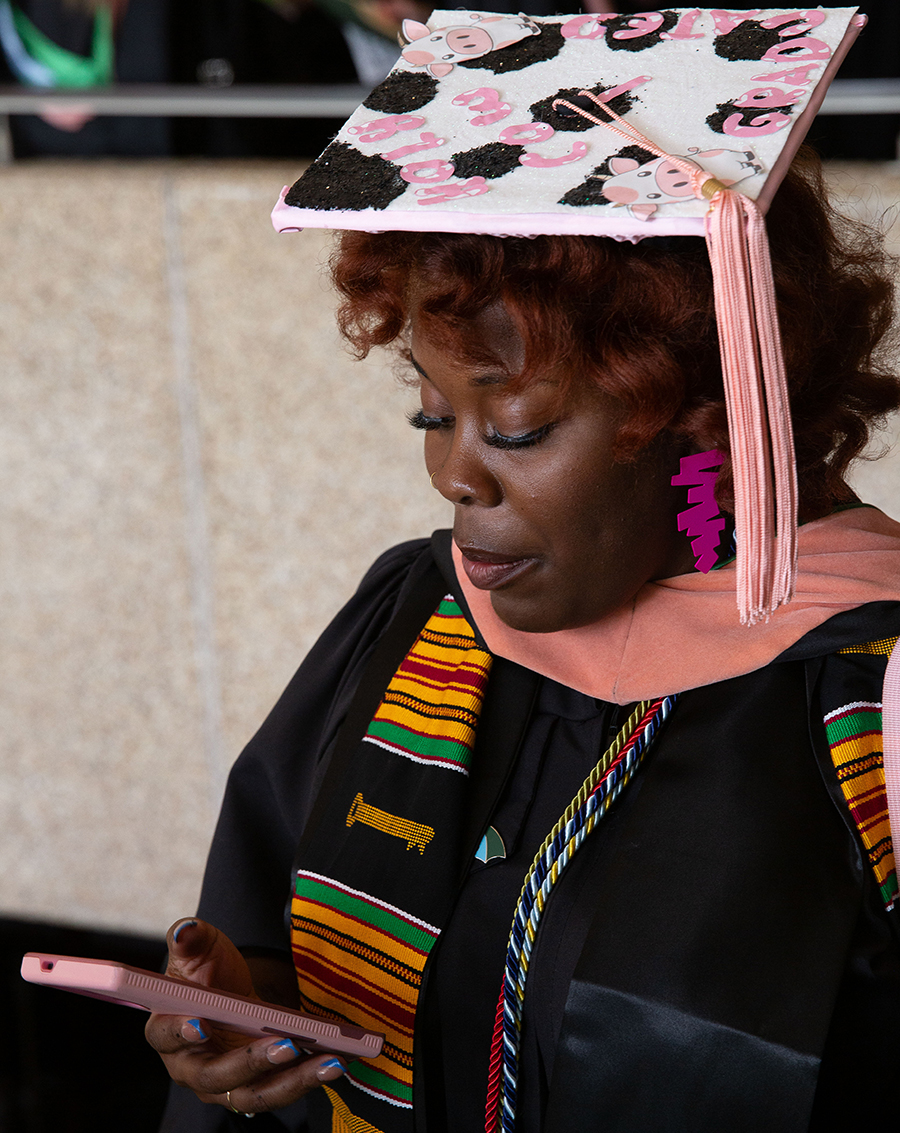 A graduate on the phone before the ceremony