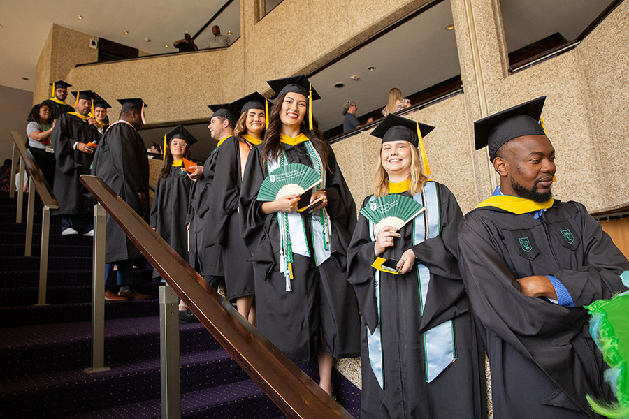 Soon to be graduates line up on the stairs at Mahalia Jackson Theater
