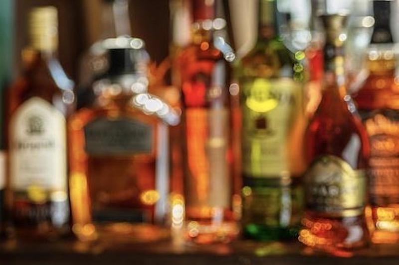 Out of focus lineup of alcohol bottles