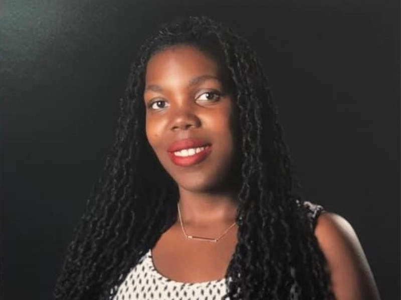 Dr. Erica Valenzuela headshot. Dark background.