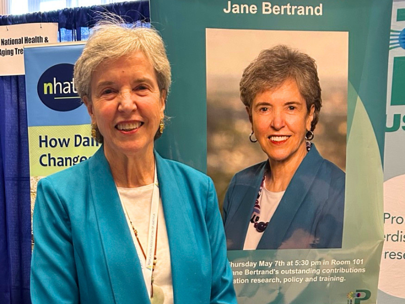 Jane Bertrand poses in front of a marquee bearing her name and likeness.