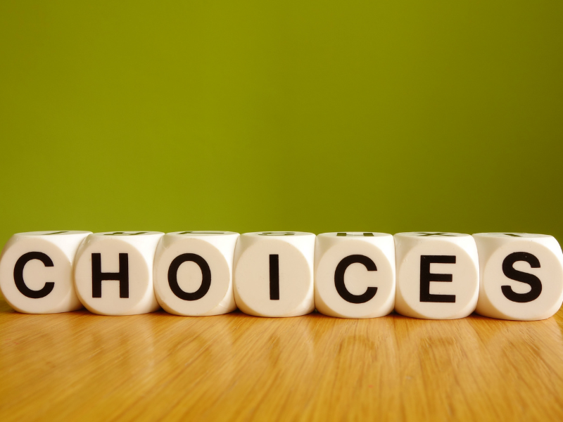 Letters on a table spelling out "Choices"