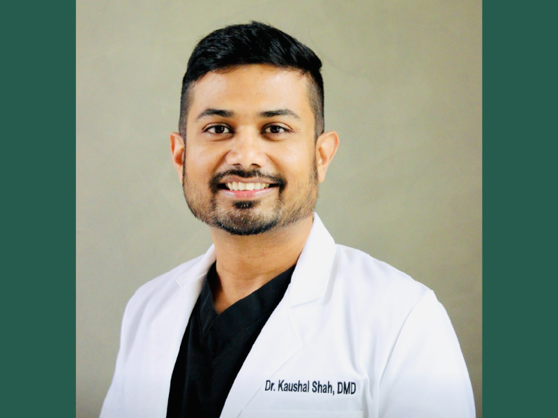 Dr. Kaushal Shah, smiling in a white lab coat.