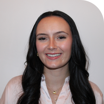 young white lady headshot with long black hair and rose gold silk top