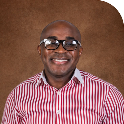 black bald man in glasses smiling with horizontally striped red and white shirt