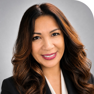 white young lady with wavy hair smiling in a black suit and white inner shirt