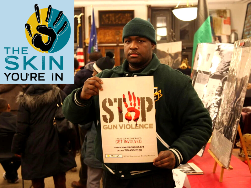 Young man holding a "stop the violence" sign