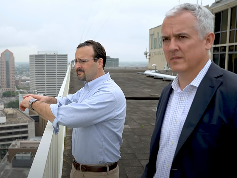 Photo of Dr. Mark Wilson and Dr. Stephen Murphy standing on a roof looking out at New Orleans.