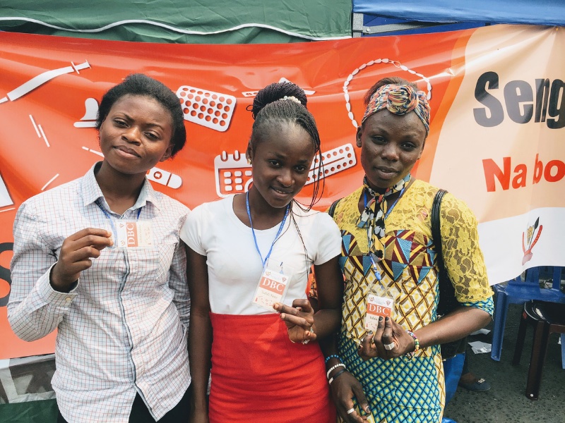 Three young woman from the Democratic Republic of the Congo pose together at a family planning event