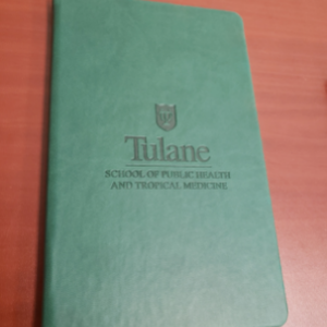 Image of a green Tulane SPHTM notebook
