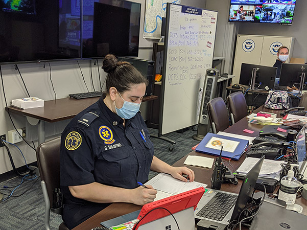 Photo of Shayna Goldfine working at a desk at the New Orleans Homeland Security and Emergency Preparedness Office
