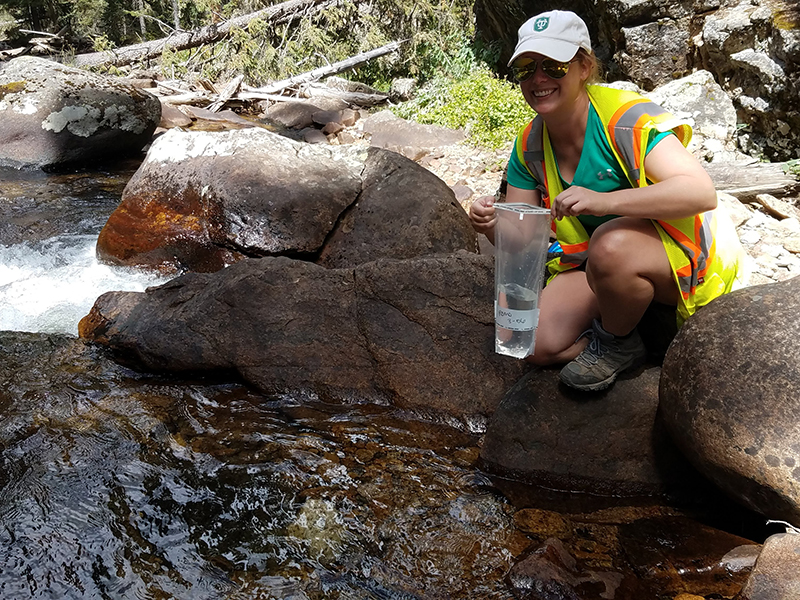 Scott takes water sample from a river in Rocky Mountain National Park