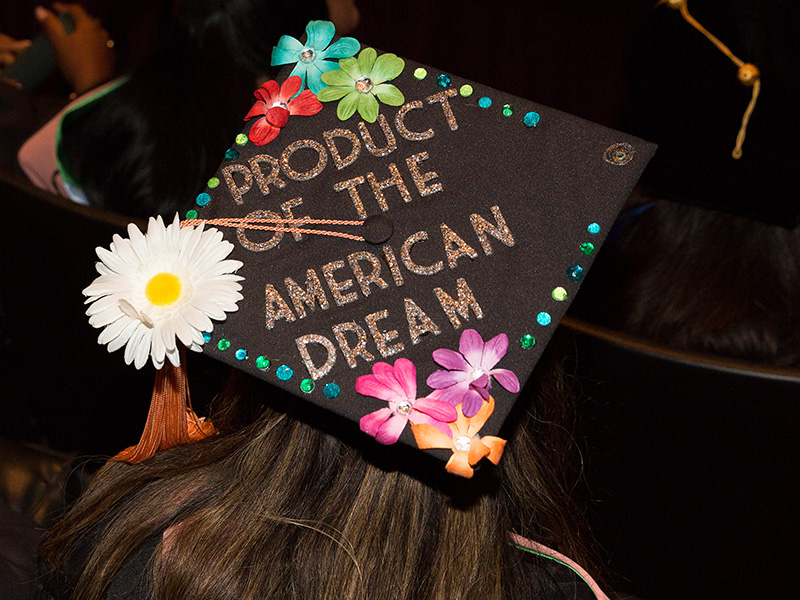 mortarboard displaying words "product of the american dream"