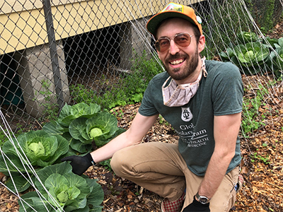 Returned Peace Corps Volunteer Christopher Taylor working in a community garden