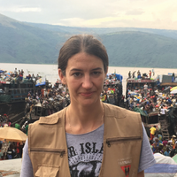 Julie Hernandez, headshot, in mountains in DRC