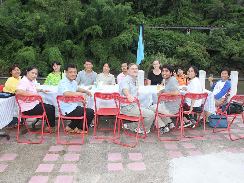 Professor Mark VanLandingham enjoying dinner with friends and colleagues