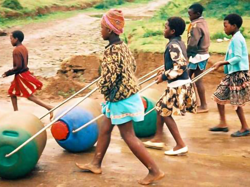 Young people in Benin, Africa transporting fresh water