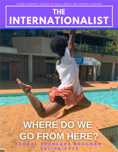 Cover image fro The Internationalist tMagazine, young woman jumping up next to a swimming pool. 