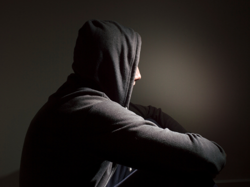 A photo of an isolated person in a hoodie