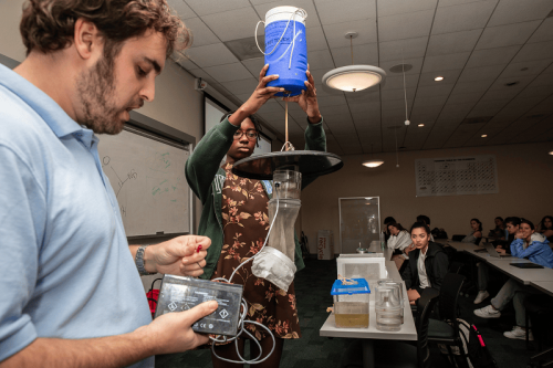 A student assists a New Orleans Mosquito, Termite, and Rodent Control Board entomologist with mosquito control vector equipment.