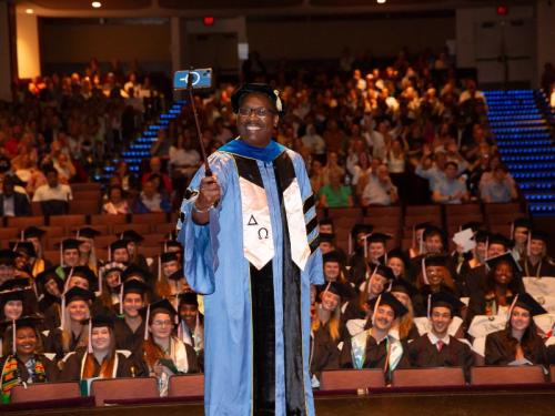 2024 SPHTM Graduation Dean LaVeist takes a selfie witht he class of 2024
