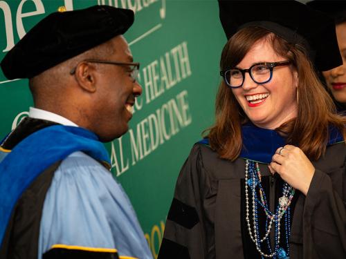 Celia Scott Weatherhead School of Public Health and Tropical Medicine Dean LaVeist with doctoral graduate Katie Vigil