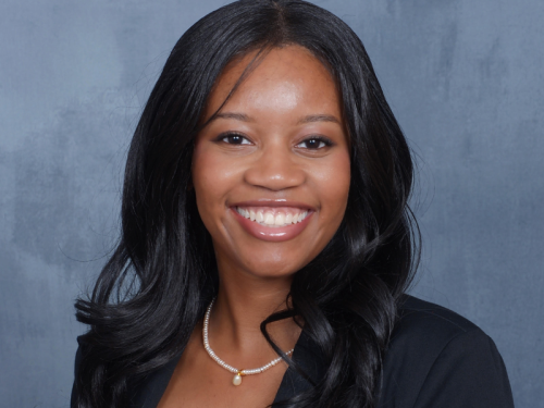 Monica Nyang'oro headshot, smiling broadly, looking directly into the camera