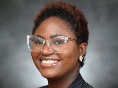 Olayinka Olajiga smiling and posing for a headshot