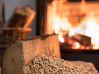 A pile of wood in front of a wood-burning stove
