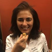 Center for Health Equity in Latin America | Celia Scott Weatherhead School of Public Health and Tropical Medicine Arachu Cstro holding a cute button that says Public Health for ALL