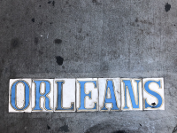 A look at the classic street tiles spelling out a street name, this one of "Orleans"