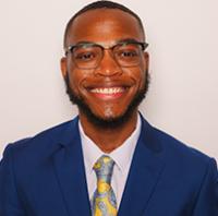 DaJon Stoudemire, wearing glasses, smiling at the camera, headshot
