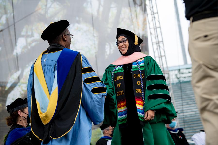 Shayma Adbalal receiving her doctorate degree from Dean LaVeist in 2021