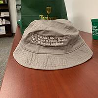 SPHTM Swag | Tulane University School of Public Health and Tropical Medicine Photo of a bucket style hat with SPHTM logo, grey hat, white logo