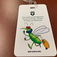 SPHTM Swag | Tulane University School of Public Health and Tropical Medicine photo of a luggage tag with an illustraveled mosquito on it, travel bug