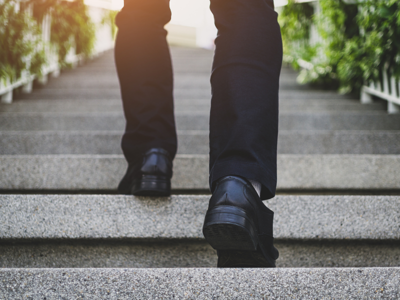 Close-up of legs walking up stairs