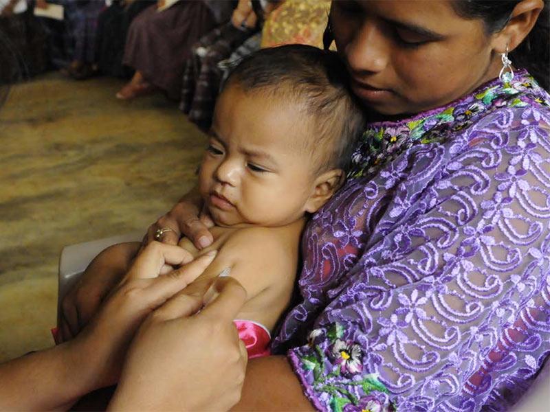 mother with infant receiving a vaccination
