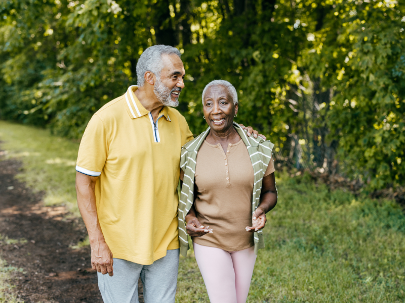 A elderly couple of color on a nature walk