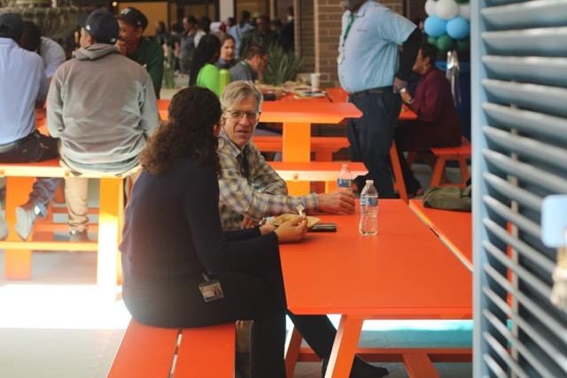 People eating and talking at the Wave City Market