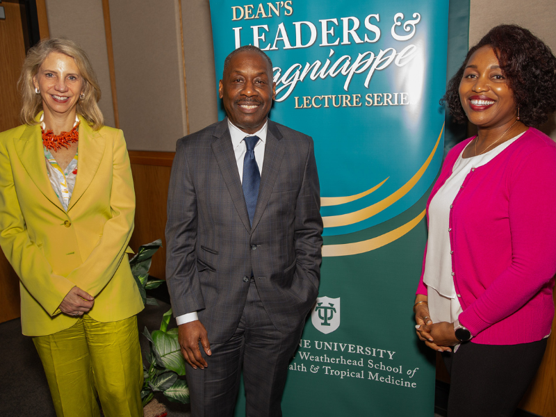 Thomas LaVeist, Rebekah Gee, and Adaeze Enekwechi smile by a university banner.
