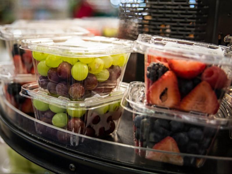 plastic containers of grapes and assorted berries